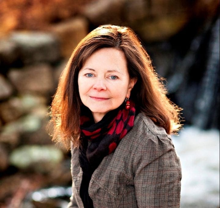 Headshot of Geraldine Brooks looking at the camera while sitting outdoors.