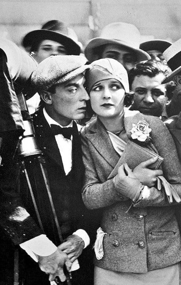 Black and white still from The Cameraman featuring Buster Keaton standing close to Marceline Day.